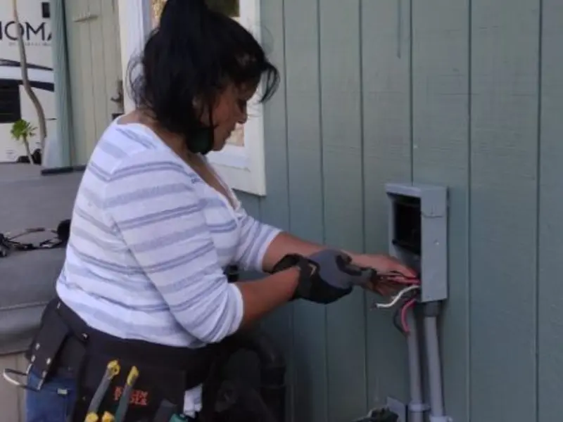 Licensed electrician wiring an exterior subpanel in Norco